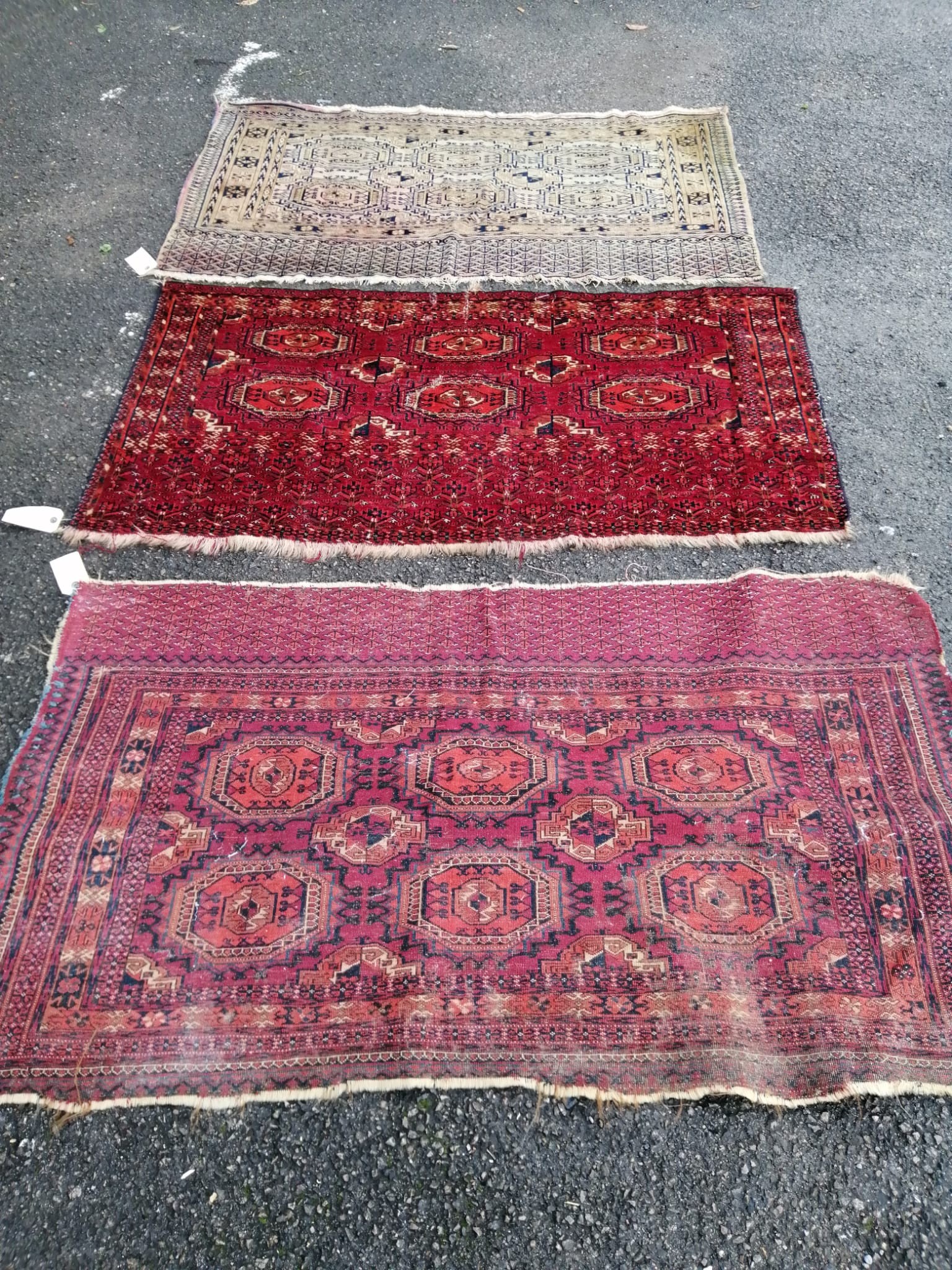 Three antique Salor mats, largest 140 x 82cm